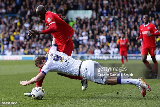 Chris Wood of Leeds United FC falls from a tackle by Alou Diarra of Charlton Athletic FC during the Sky Bet Championship match between Leeds United...