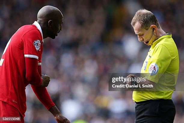 The match referee writes a penalty to Alou Diarra of Charlton Athletic FC after his tackle against Chris Wood of Leeds United during the Sky Bet...