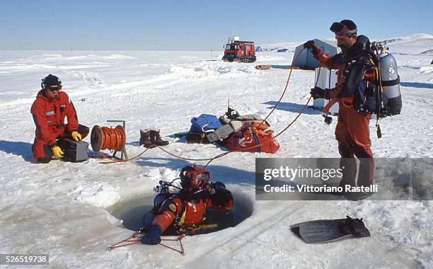 Italian researchers of the Antarctic ice sheet get ready before descending into the waters at a temperature of minus two Celsius, in Antarctica....