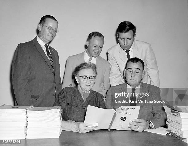 Local officials gather around to read the State of Alabama Planning Directive for Preliminary Operational Survival Planning Project in the mid-1950s.