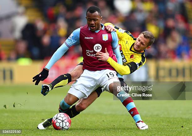 Jordan Ayew of Aston Villa and Almen Abdi of Watford compete for the ball during the Barclays Premier League match between Watford and Aston Villa at...