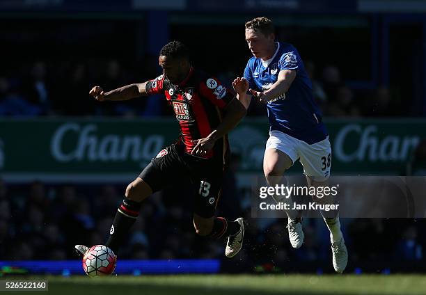 Callum Wilson of Bournemouth and Matthew Pennington of Everton compete for the ball during the Barclays Premier League match between Everton and...