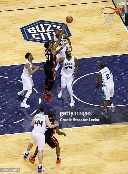 Hassan Whiteside of the Miami Heat shoots over Al Jefferson of the Charlotte Hornets during game six of the Eastern Conference Quarterfinals of the...