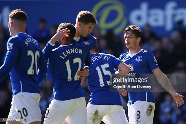 Leighton Baines of Everton celebrates scoring his team's second goal with his team mates during the Barclays Premier League match between Everton and...