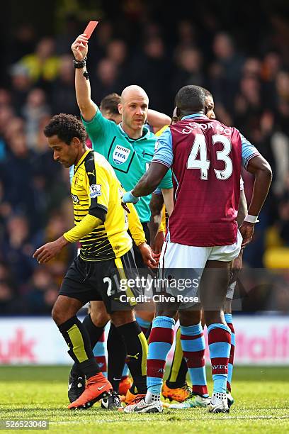 Aly Cissokho of Aston Villa is shown a red card by referee Anthony Taylor during the Barclays Premier League match between Watford and Aston Villa at...