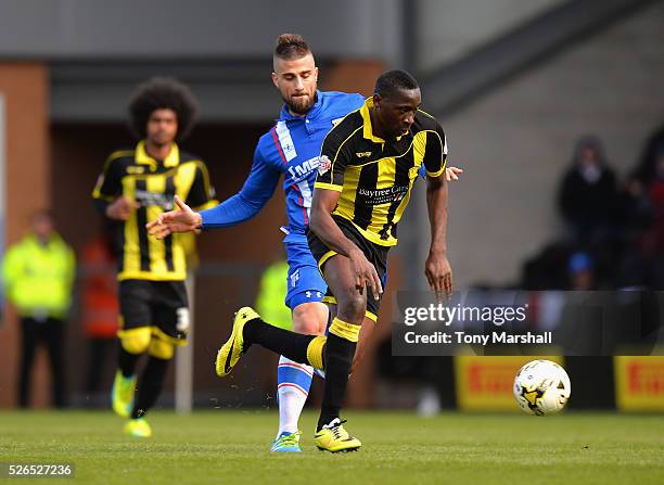 Lucas Akins of Burton Albion is challenged by Max Ehmer of Gillingham during the Sky Bet League One match between Burton Albion and Gillingham at...