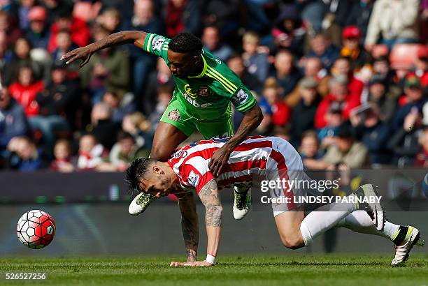 Sunderland's English forward Jermain Defoe vies with Stoke City's US defender Geoff Cameron during the English Premier League football match between...