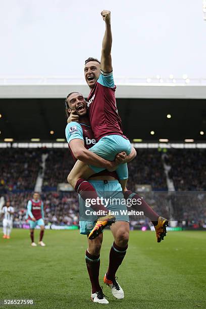 Mark Noble of West Ham United celebrates scoring his team's third goal with his team mate Andy Carroll during the Barclays Premier League match...