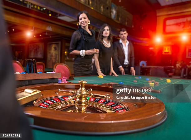 group of young people playing roulette - roulette stock pictures, royalty-free photos & images