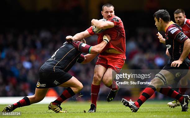 Ken Owens of the Scarlets breaks the tackle of Brok Harris of Newport during the Guinness Pro 12 match between Newport Gwent Dragons and Scarlets at...