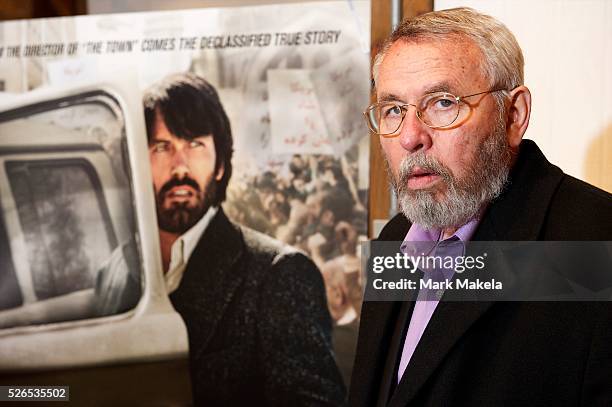 Retired CIA operative Tony Mendez photographed at his gallery in rural Maryland with the movie poster of Argo, and Ben Affleck in his role on...