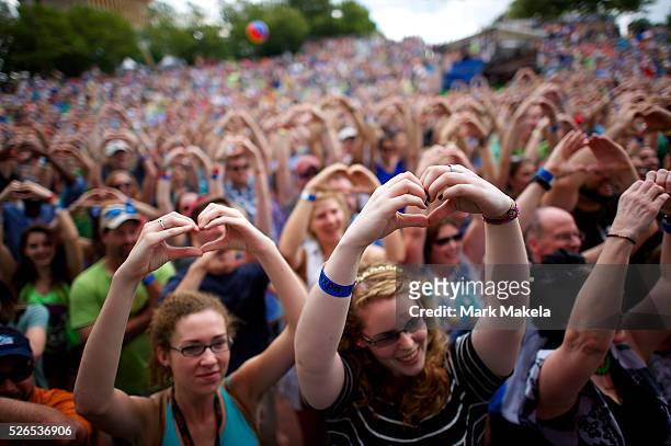 The crowd makes heart shapes with their hands on request from singer songwriter Kelsey Kopecky of the Kopecky Family Band during the XPONENTIAL Music...