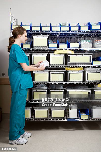 nurse in intensive care unit supply room - storage room stock pictures, royalty-free photos & images