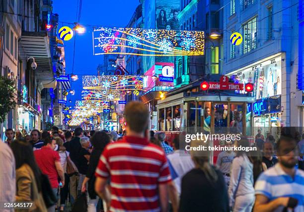 people walking at crowded istiklal street of istanbul turkey - istiklal avenue stock pictures, royalty-free photos & images