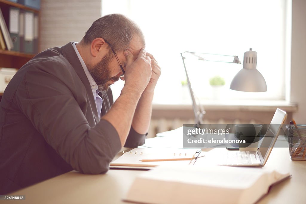 Mature Adult man working in the office