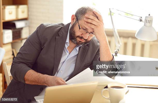 mature adult man working in the office - filing documents stock pictures, royalty-free photos & images