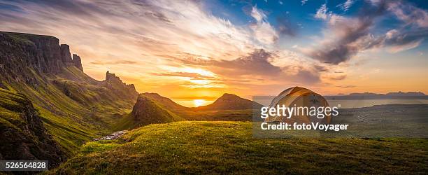 golden sunrise illuminating tent camping dramatic mountain landscape panorama scotland - schotland stockfoto's en -beelden