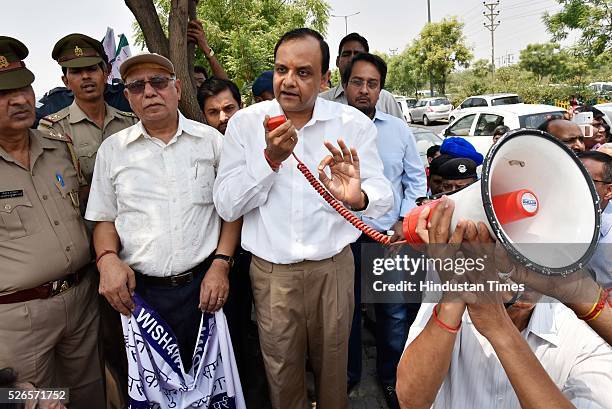 Jaypee Group Executive Chairman and CEO Manoj Gaur greets agitating home buyers as they are protesting against delayed deliveries of purchased...