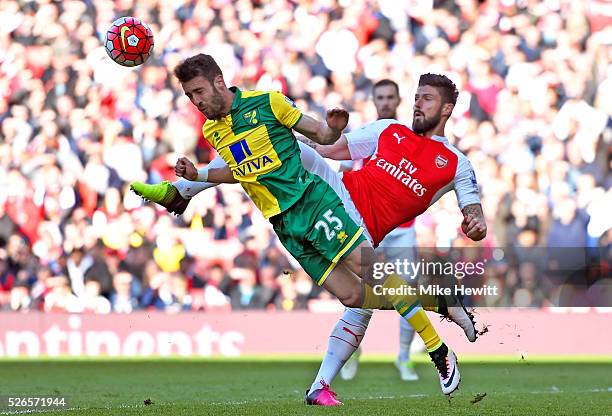 Ivo Pinto of Norwich City clears the ball in front of Olivier Giroud of Arsenal during the Barclays Premier League match between Arsenal and Norwich...