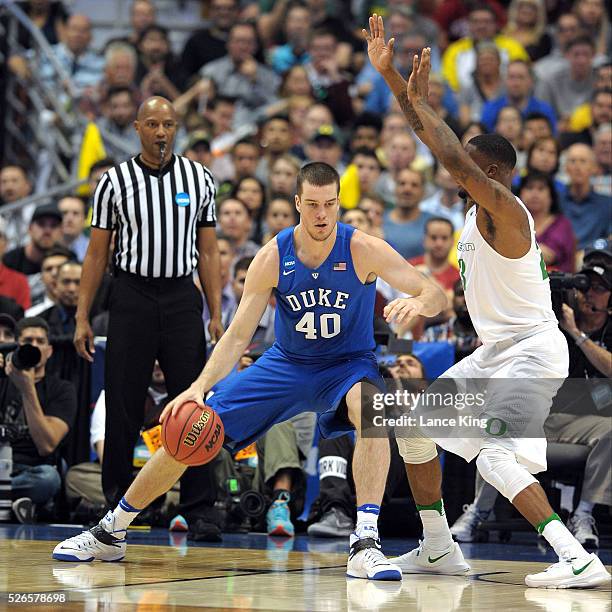 Marshall Plumlee of the Duke Blue Devils moves the ball against Elgin Cook of the Oregon Ducks during the West Regional Semifinal of the 2016 NCAA...