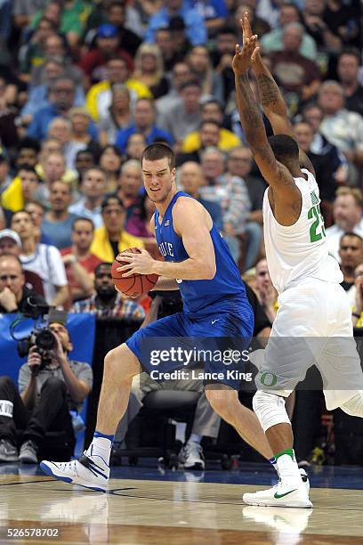 Marshall Plumlee of the Duke Blue Devils moves the ball against Elgin Cook of the Oregon Ducks during the West Regional Semifinal of the 2016 NCAA...