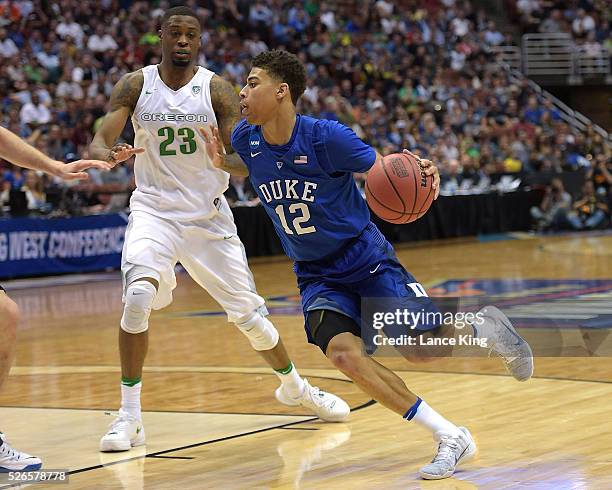 Derryck Thornton of the Duke Blue Devils drives against Elgin Cook of the Oregon Ducks during the West Regional Semifinal of the 2016 NCAA Men's...