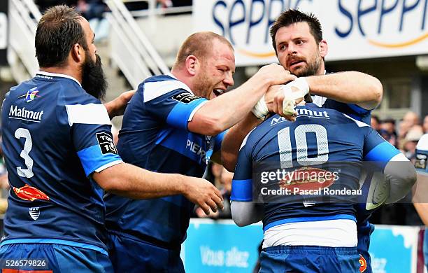 Rodrigo Capo Ortega;Mihaita Lazar and Benjamin Urdapilleta from Castres celebrates after a trial during the French Top 14 rugby union match between...