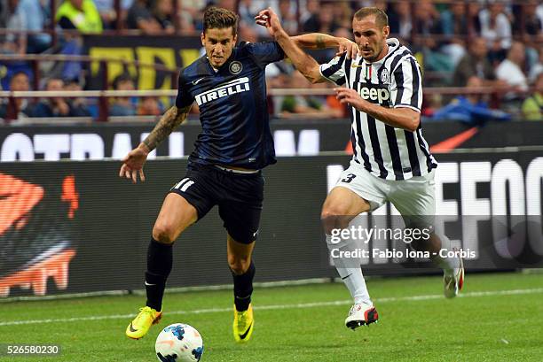 Inter Milan's Argentinian midfielder Ricky Alvarez fights for the ball with Juventus' Midfielder Arturo Vidal during the serie A football match Inter...