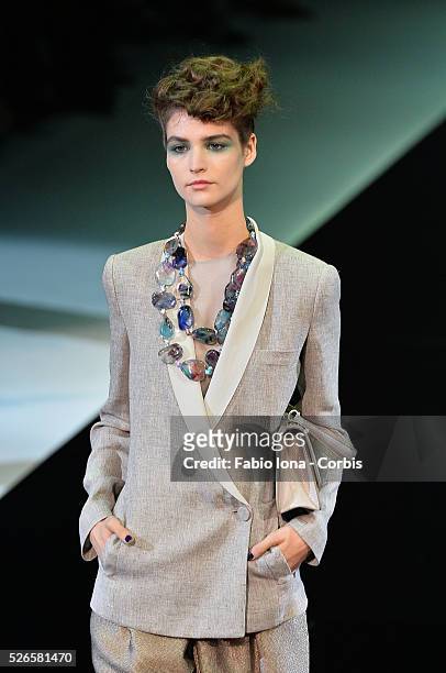 Model walks the runway at the Giorgio Armani Spring Summer 2014 fashion show during Milan Fashion Week on September 23, 2013 in Milan, Italy