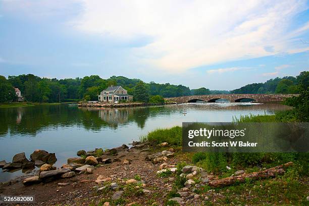 riverfront mansion in darien ct with stone bridge - darien connecticut house stock pictures, royalty-free photos & images