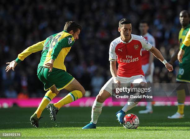 Mesut Ozil of Arsenal takes on Gary O'Neil of Norwich during the Barclays Premier League match between Arsenal and Norwich City at on April 30th,...