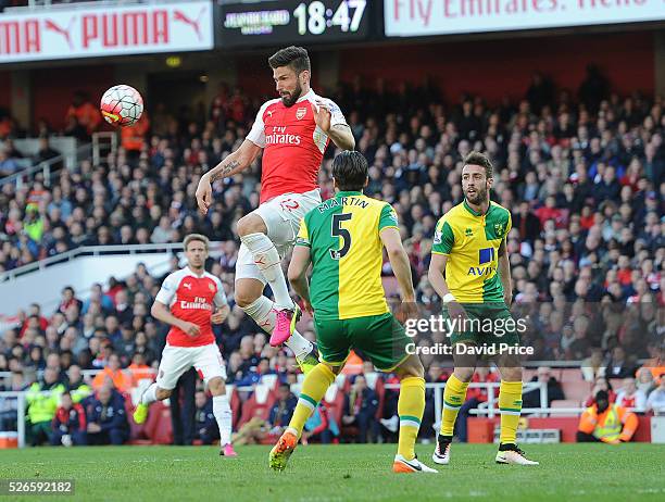 Olivier Giroud of Arsenal lays the ball off for Arsenal's goal under pressure from Russell Martin of Norwich during the Barclays Premier League match...