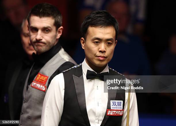 Mark Selby of England and Marco Fu of Hong Kong during their semi final match against on day fifteen of the World Championship Snooker at Crucible...