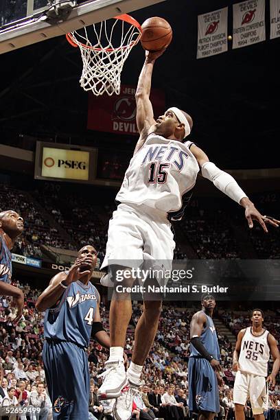 Vince Carter of the New Jersey Nets drives to the hoop as Antawn Jamison of the Washington Wizards watches on April 19, 2005 at the Continental...
