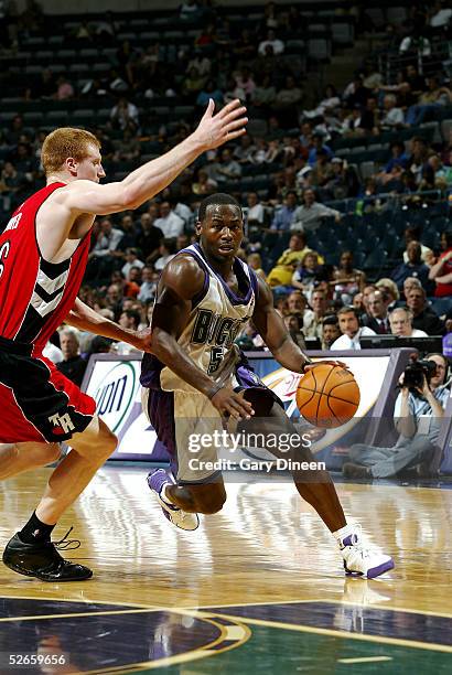 Anthony Goldwire of the Milwaukee Bucks drives to the basket against Matt Bonner of the Toronto Raptors on April 19, 2005 at the Bradley Center in...