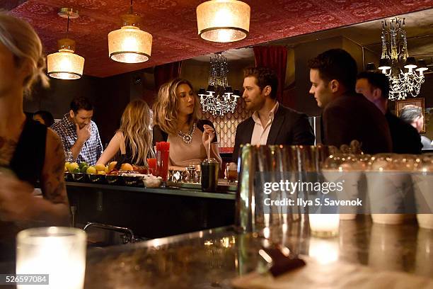 Tony Romo, Candice Crawford-Romo, Renee Morrison and Matthew Morrison sit at the bar during Eric Podwall's exclusive cocktail experience the evening...