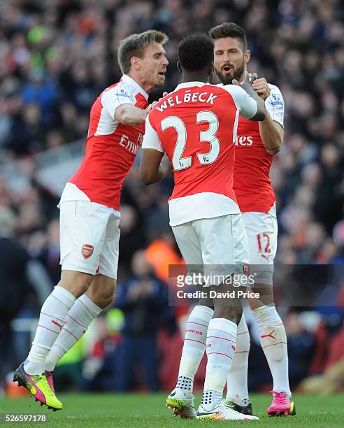 Danny Welbeck celebrates scoring Arsenal's goal with Olivier Giroud and Nacho Monreal of Arsenal during the Barclays Premier League match between...