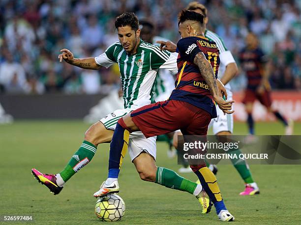 Barcelona's Brazilian forward Neymar vies with Betis' midfielder Alvaro Cejudo during the Spanish league football match Real Betis Balompie vs FC...