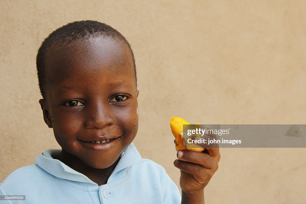 Boy eating mango