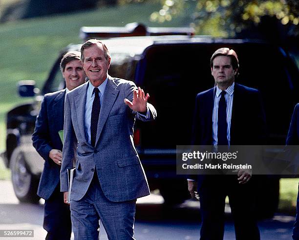 Washington, DC 9-1989 President George H. W. Bush waves to the press as he walks from the Oval Office towards Marine One for trip to Andrews Air...