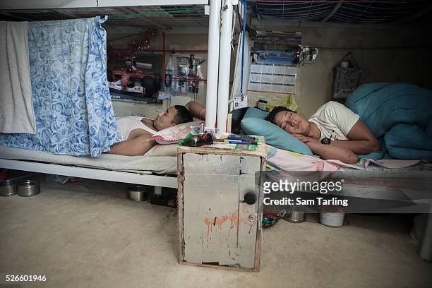 Migrant construction workers sleep in their bunk-beds in a shared room at a workers' camp in al-Khor, Qatar, on June 17, 2011. According to the...