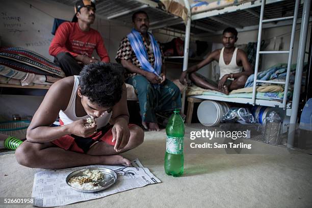 Migrant constructions workers rest in a shared room at a workers' camp in al-Khor, Qatar, on June 17, 2011. According to the advocacy group Human...