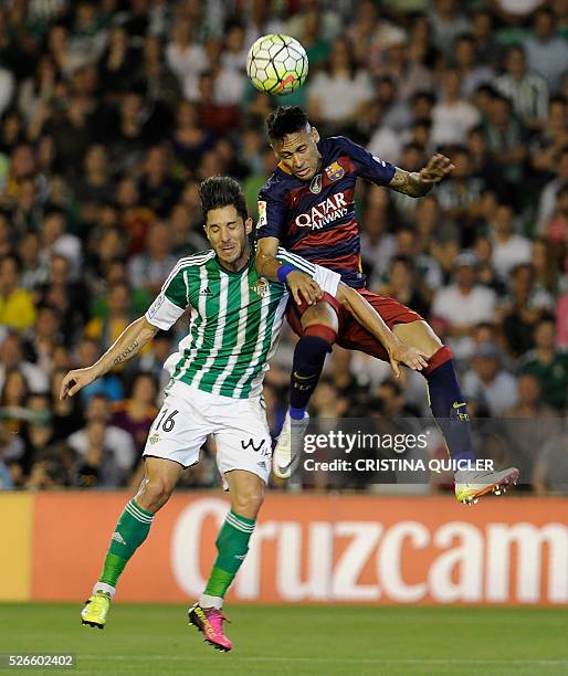 Barcelona's Brazilian forward Neymar vies with Betis' midfielder Alvaro Cejudo during the Spanish league football match Real Betis Balompie vs FC...