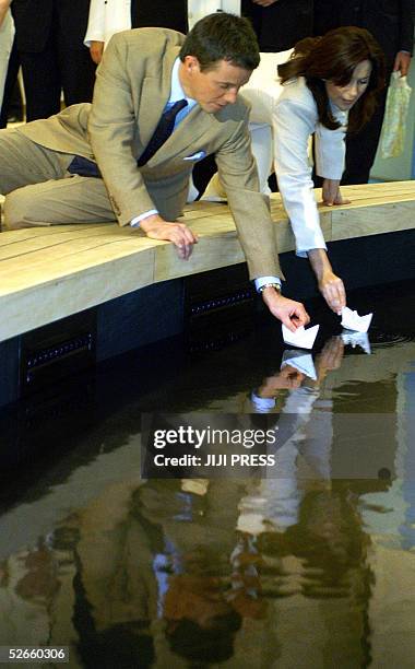 Denmark's Crown Prince Frederik Andre Henrik Christian and Australian-born Crown Princess Mary set paper-made ships as part of their visit to the...