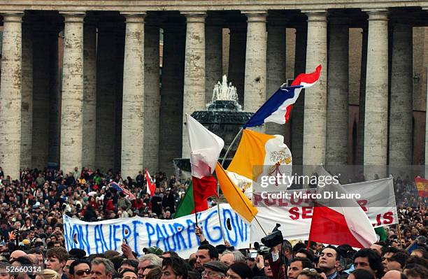 The crowd listens to German Cardinal Joseph Ratzinger speak after appearing on the balcony of St.Peter's Cathedral as Pope Benedict XVI at the end of...