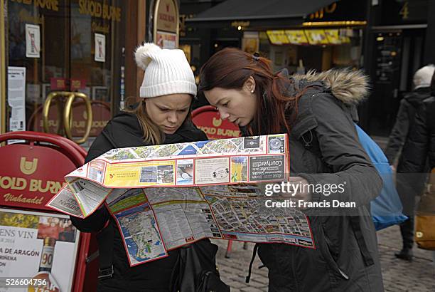 February 2014 _Felame travelers studing Copenhagen city map at kongens nytorv