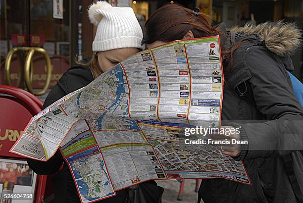 February 2014 _Felame travelers studing Copenhagen city map at kongens nytorv