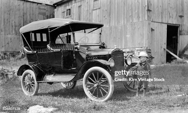 Young boy with the family Model T, on the farm, ca. 1917