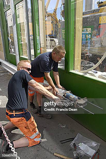 Two males working on metro computer train station at kongens nytorv stations project today on 26 JUNE 2014