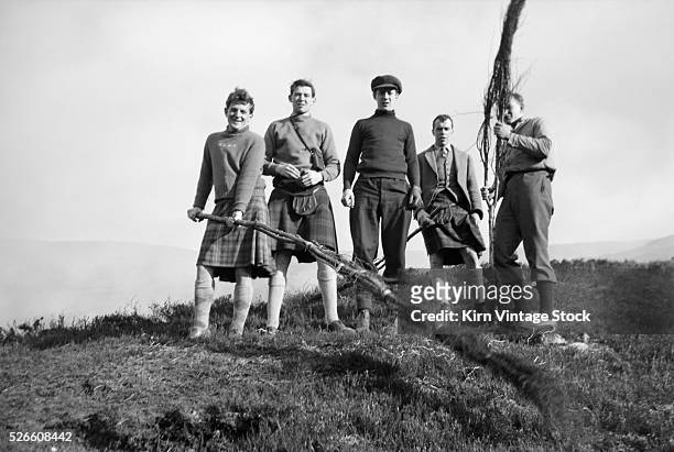 Group of young men gather for a picture before working a controlled burn of the heathlands and moors in Scotland in the 1930s.